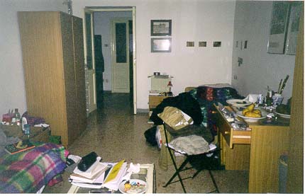 My bed is in the far corner to the right of the door